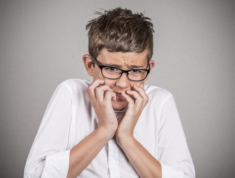 Headshot anxious stressed boy isolated on grey background 