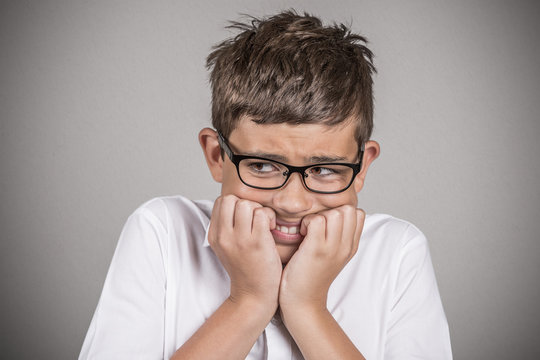 Headshot anxious stressed boy isolated on grey background 