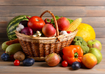 Fototapeta na wymiar Fresh organic fruits and vegetables on wooden background