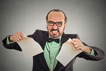 angry businessman tearing a document to pieces