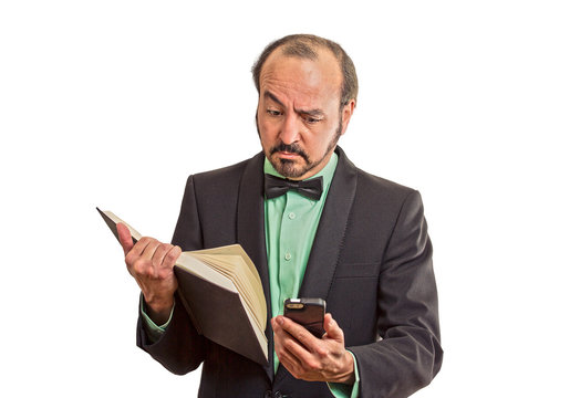 skeptical man reading news on smartphone, holding book