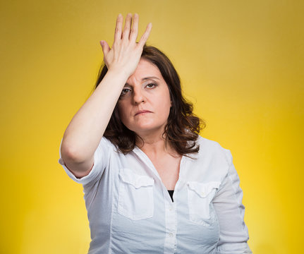 woman with palm on face gesture in duh moment
