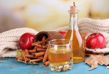 Composition of  apple cider with cinnamon sticks, fresh red