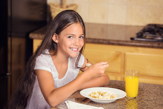 Girl Eating Cereal With Milk