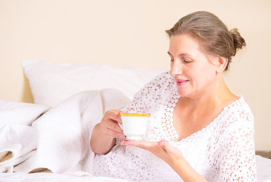 woman having breakfast, relaxing in hotel house home bed