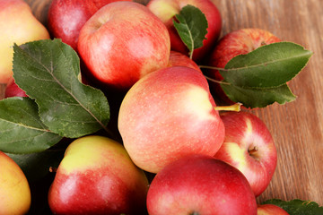 Ripe red apples on wooden background