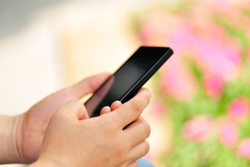 young woman hands use cellphone in city 