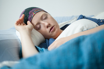 Young woman having tumor sleeping