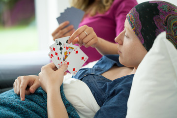 Cancer girl playing cards