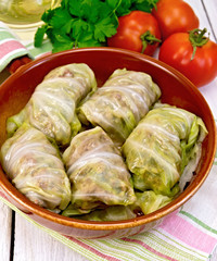 Cabbage stuffed with sauerkraut in ceramic pan on napkin