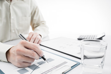 Naklejka premium Close-up of graphs and charts analyzed by businessman