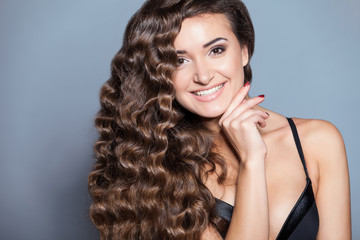 Portrait of a young brunette woman with beautiful hair