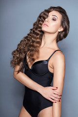 Fototapeta premium Portrait of a young brunette woman with beautiful hair