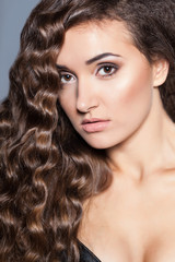 Portrait of a young brunette woman with beautiful hair