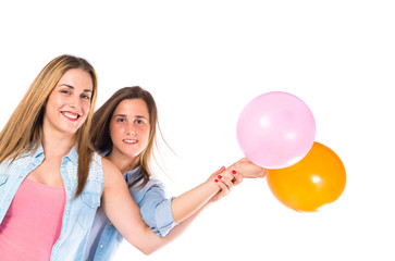 Fototapeta na wymiar Friends with many balloons over white background