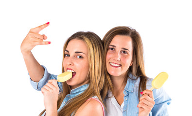 Friends eating ice cream over white background