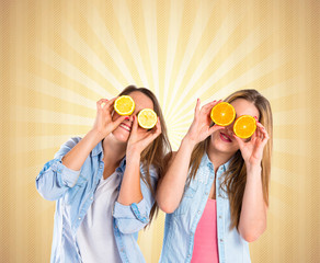 Friends playing with fruits over pop background