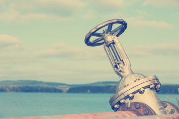 Old fuel pipe valve in an abandoned harbor