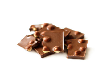 Pile of chocolate with nuts on white background