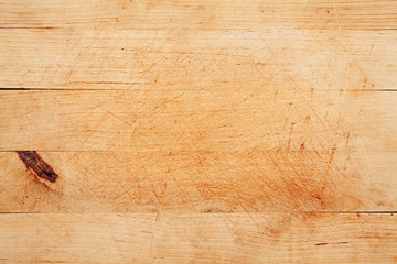 Wood kitchen table with cutting marks. Wood texture background.