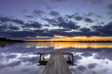 Purple Sunset over Wooden Jetty in Tranquil Lake