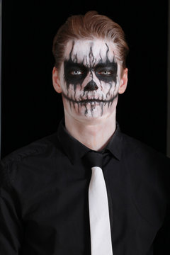 Portrait man with Halloween skull makeup. Halloween or horror th