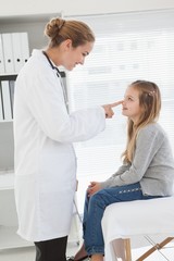 Fototapeta premium Smiling doctor touching patients nose