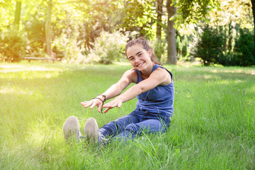 smiling teenage girl trying to touch the feet with their hands