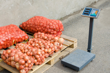 Scales near bags of onion