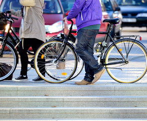 Man and woman walking with bikes