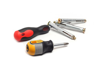 screwdrivers and anchor bolts on a white background