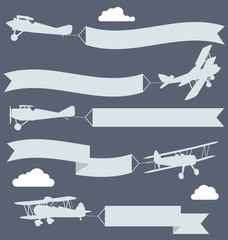 Silhouettes of biplanes with wavy greetings banner