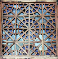 Decorative carved wooden lattice on the old window