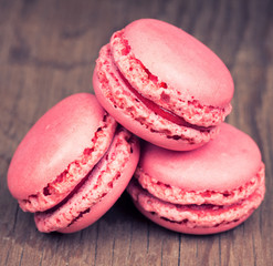 Pink macaroons on retro vintage wooden background