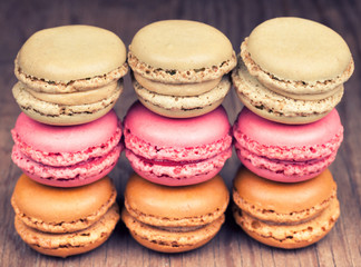 Colorful fresh delicious macaroons on vintage wooden background