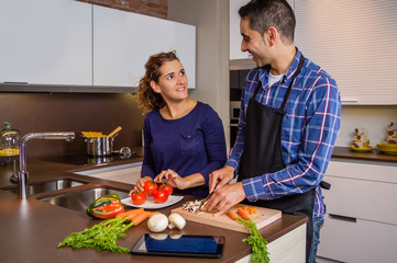 Couple in home kitchen prepairing healthy food