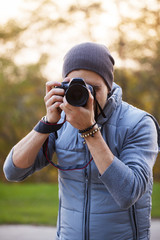 Photographer with camera shooting outdoor scenery.
