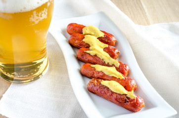 Roasted sausages with glass of beer