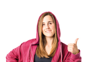 Pretty young girl with thumbs up over white background