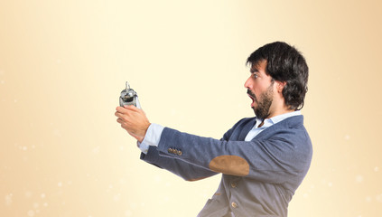 Man holding a clock over ocher background
