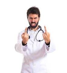 Doctor making horn gesture over white background