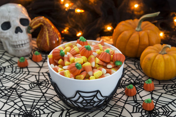 Bowl of candy corn and melocreme pumpkins  in a Halloween theme