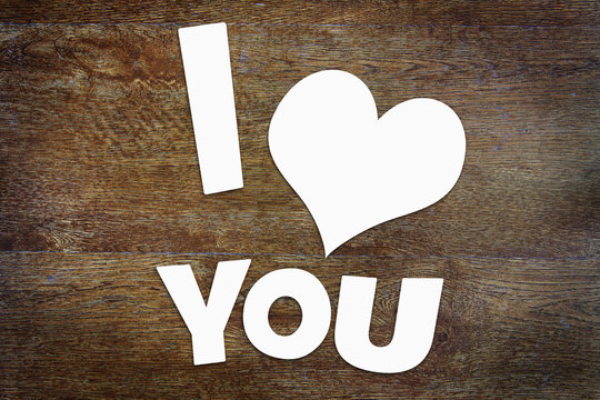 Text I Love You over wooden background