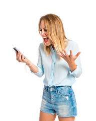 Frustrated girl talking to mobile over white background