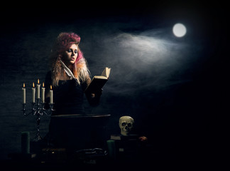 Beautiful witch making witchcraft over on Halloween