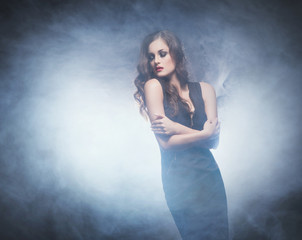 Young and emotional woman in fashion dress over glamour backgrou