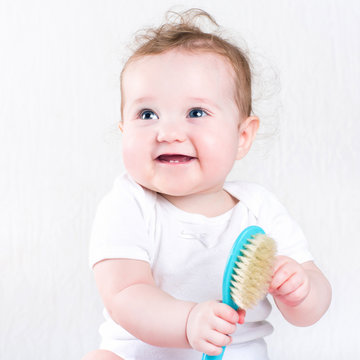 Pretty Baby Girl Playing With A Hair Brush