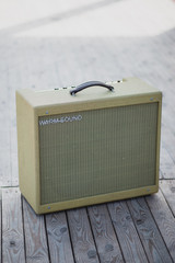 Obraz premium Yellow vintage guitar aplifier on wooden floor