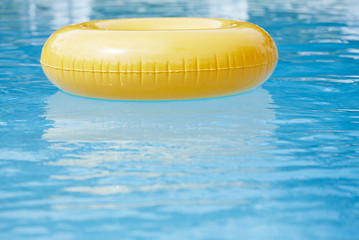 floating ring on blue water swimpool with waves reflecting - 71329015