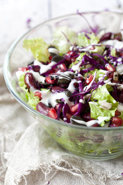 mixed salad with beans, seeds, purple cabbage and yogurt sauce